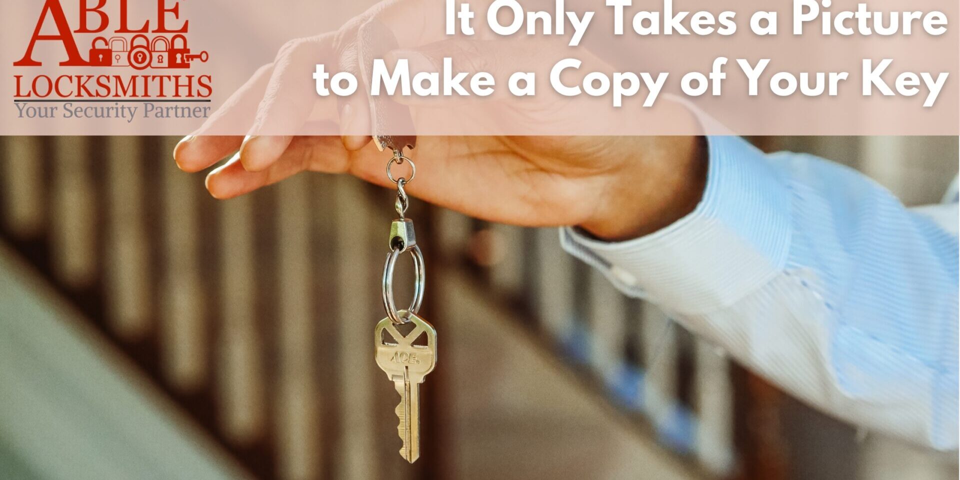 A hand dangles a key, showing all of the cuts along the blade. Able wants you to be aware that a copy can made from a simple picture likes this.