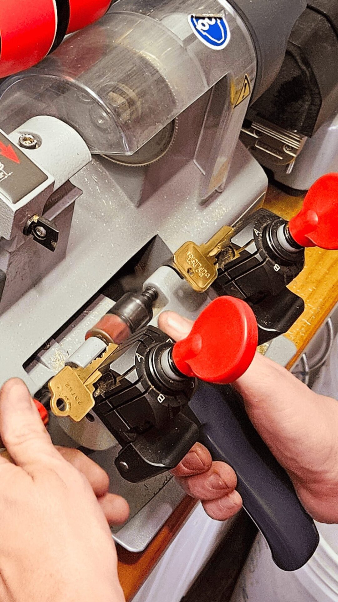 A key is being duplicated on a key machine by a technician at Able Locksmiths, LLC in Frederick, MD