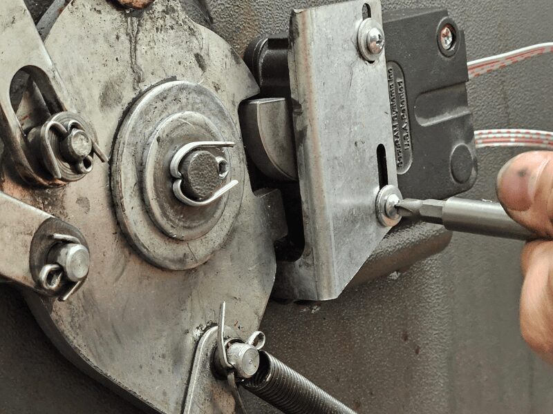 An Able Locksmiths Security Expert services a safe lock. 